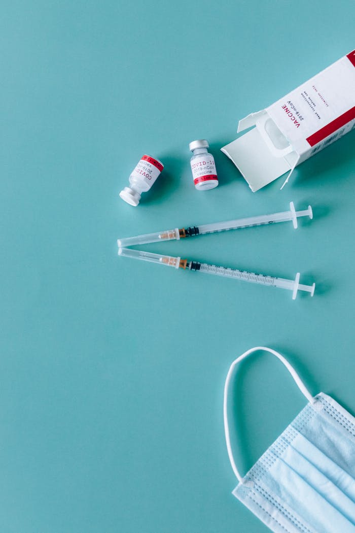 services-01 Syringes, vaccine vials, and face mask ready for COVID-19 vaccination.